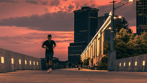 A runner, running through the city during sunset