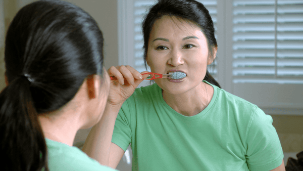 woman brushing teeth
