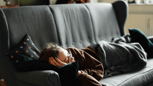 A person sleeping on a sofa