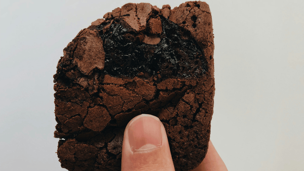 Someone holding a melting brownie 