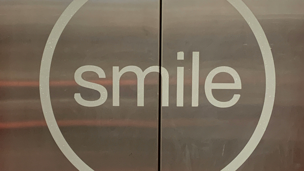 Smile poster on an elevator 