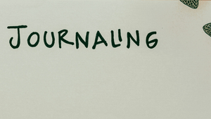 'Journaling' written on a note book 