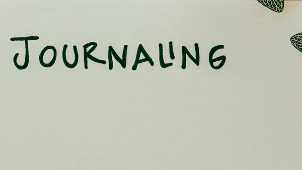 'Journaling' written on a note book 