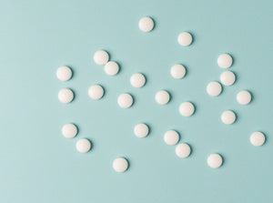 A blue background with mints scattered across it