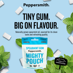 Peppersmith Mighty Pouch spearmint gum packaging on a light blue background with floating gum pieces and mint leaves. Large text reads 'TINY GUM.
